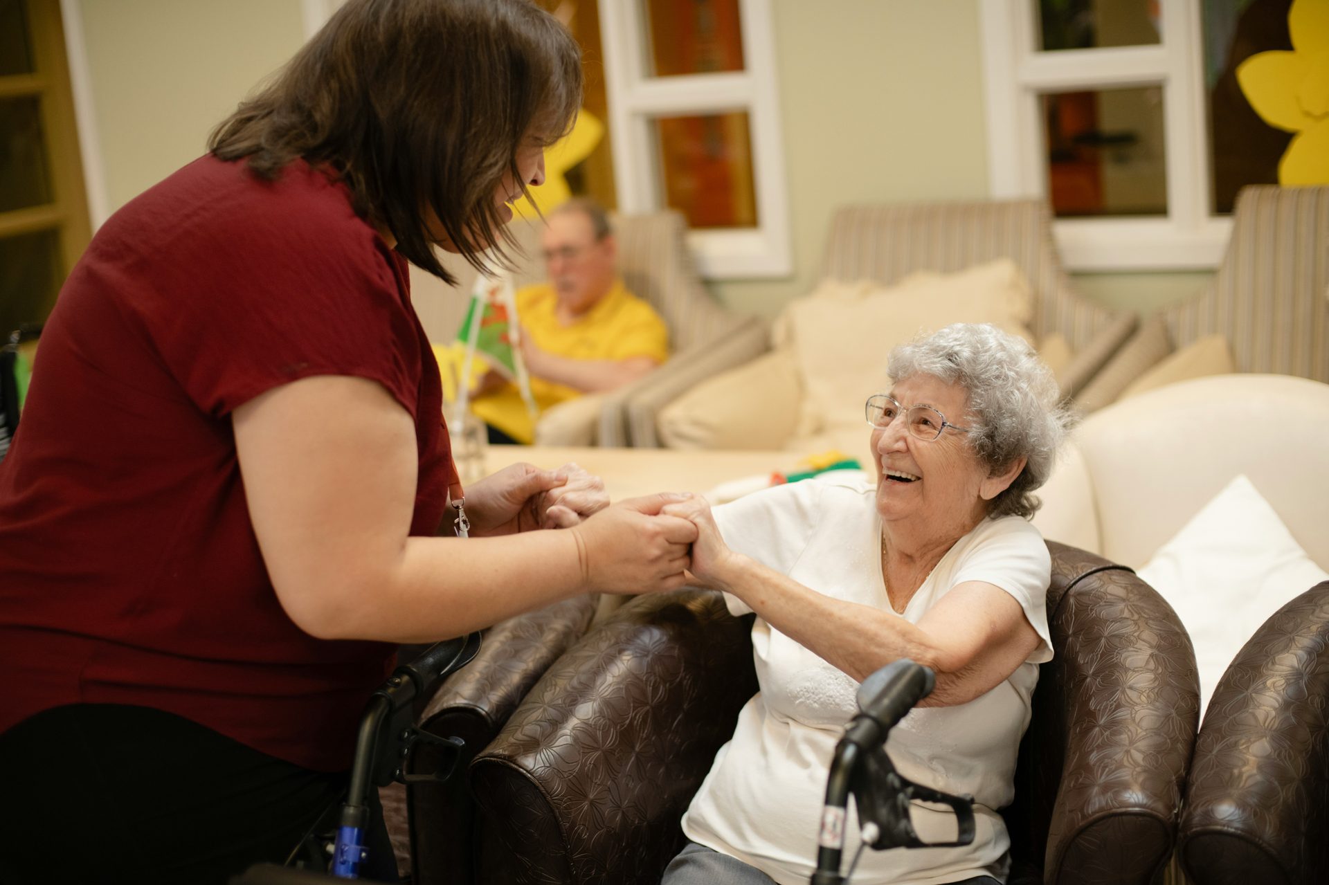 A caregiver connecting warmly with a resident in a community care setting, reflecting the staff NorthernEdge places in care organizations.